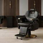 Fauteuil de barbier professionnel noir et doré avec appuie-tête et repose-pieds mobile